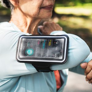 Woman exercising with phone on arm strap