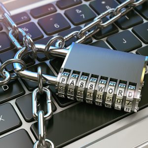 Padlock and chain on laptop keyboard