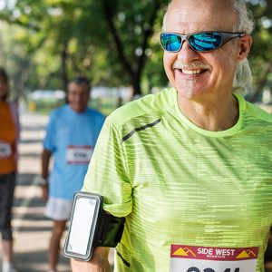 Runner with sunglasses and phone on arm strap